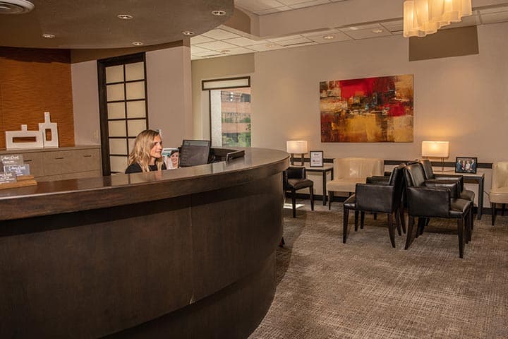 Meet our Staff Dr. Rossow DDS, Laura Noce DMD, Joseph Burns DDS, Cheri Neal DDS. Aspen Dental General, Cosmetic, Restorative, Preventative, Family Dentistry dentist in Denver CO 80206 Aspen Dental Front Desk with Smiling Secretary